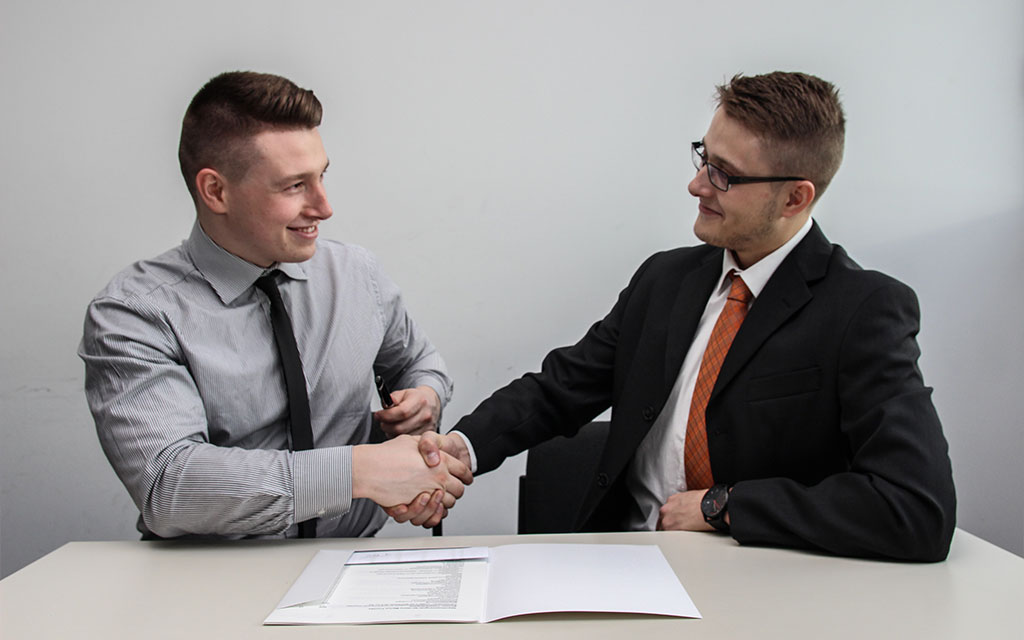 two men shaking hands at a recruitment interview